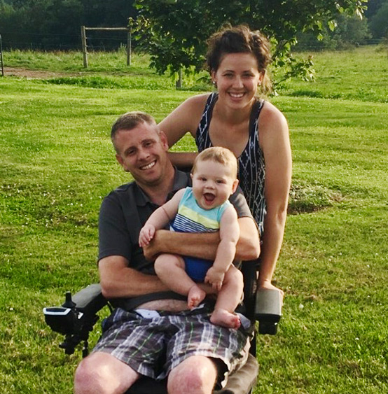Racer Brian Steinman in his off-road wheelchair with his wife and kid